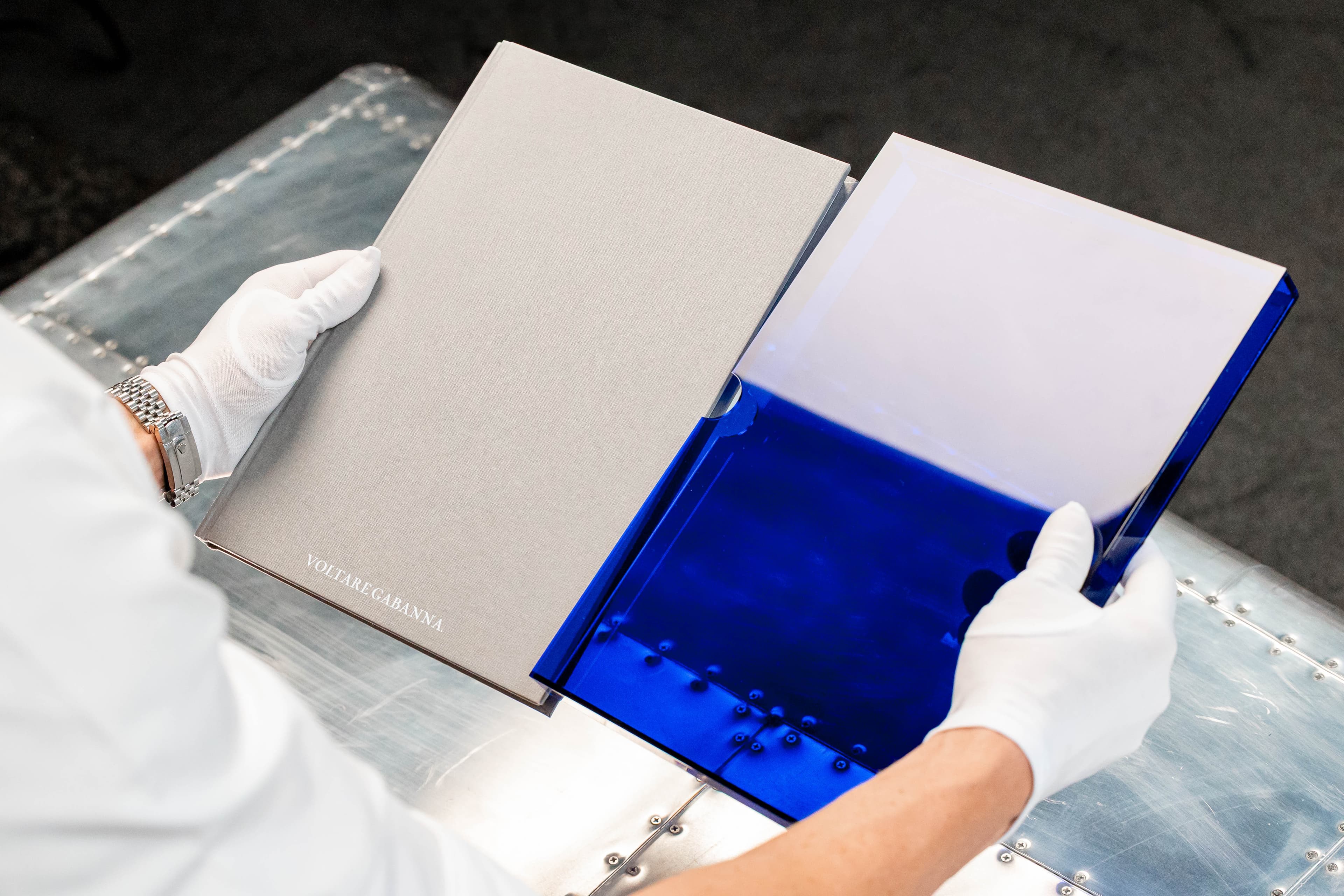 The Unveiled album being unboxed from its royal blue perspex case